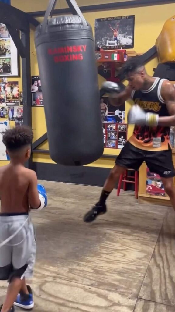 Blueface in home gym with his son